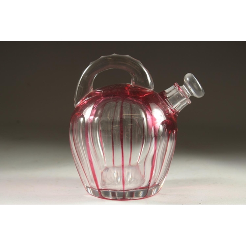 1103 - A SLICE CUT RUBY TINTED GLASS EWER with stopper. 7ins high.