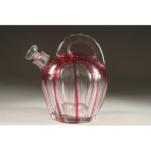 1103 - A SLICE CUT RUBY TINTED GLASS EWER with stopper. 7ins high.