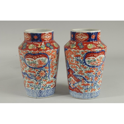 1239 - A PAIR OF IMARI VASES. 9.5ins high.