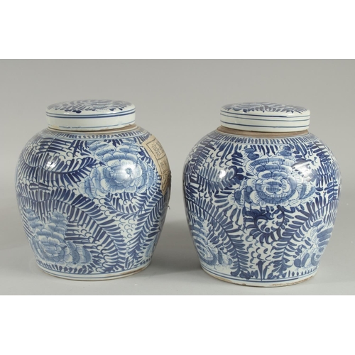 1240 - A PAIR OF CHINESE BLUE AND WHITE GINGER JARS AND COVERS 9.5ins high.