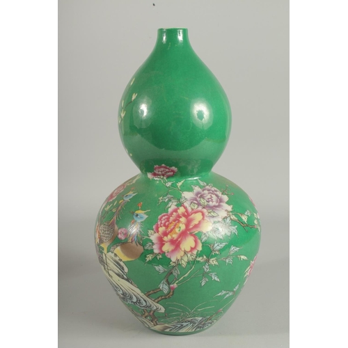 1242 - A CHINESE GREEN PORCELAIN DOUBLE GOURD VASE decorated with flowers. Six-character mark in blue.