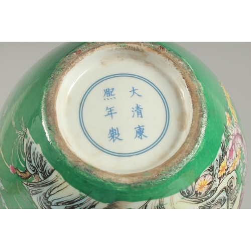 1242 - A CHINESE GREEN PORCELAIN DOUBLE GOURD VASE decorated with flowers. Six-character mark in blue.