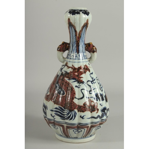 1243 - A CHINESE BLUE AND BRONZE GARLIC HEAD VASE with dragon design.