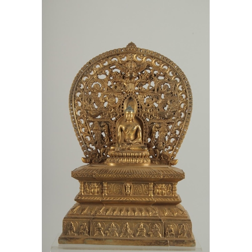 1250 - A GOOD GILT BRONZE BUDDHA with halo, on a rectangular base. 11ins high.