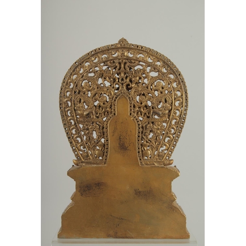 1250 - A GOOD GILT BRONZE BUDDHA with halo, on a rectangular base. 11ins high.