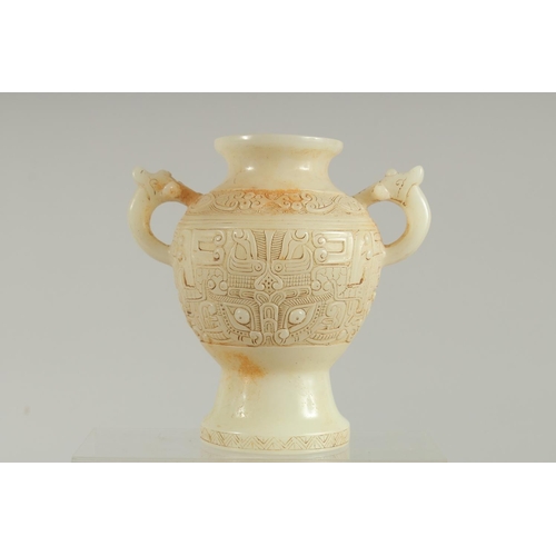 1261 - A CHINESE CARVED WHITE JADE TWO HANDLED VASE. 7ins high.