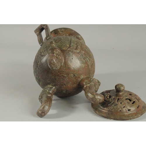 1262 - A CHINESE CARVED TWO HANDLED BRONZE CENSER AND COVER On three curving feet.. 12ins high.