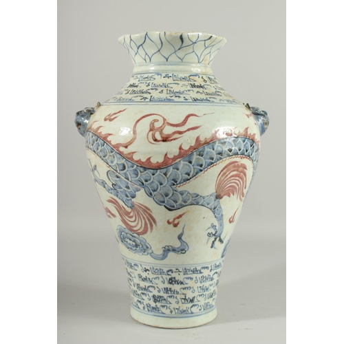 1268 - A LARGE CHINESE BLUE AND WHITE VASE with dragon decoration. 17ins high.