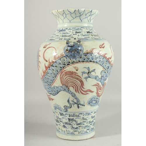 1268 - A LARGE CHINESE BLUE AND WHITE VASE with dragon decoration. 17ins high.