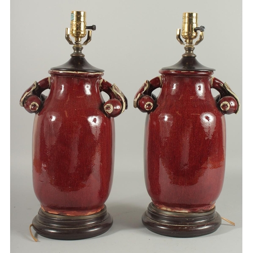 1273 - A PAIR OF CHINESE SANG DE BOEUF PORCELAIN LAMPS. 18ins high.