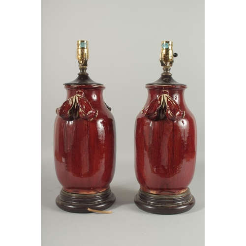 1273 - A PAIR OF CHINESE SANG DE BOEUF PORCELAIN LAMPS. 18ins high.