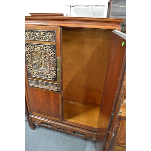 1042 - A CHINESE TWO DOOR CUPBOARD  with carved and gilt decorated panelled doors. 3ft 4ins wide , 5ft 2ins... 