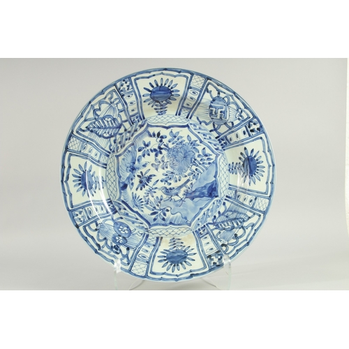 104 - A CHINESE EXPORT BLUE AND WHITE PORCELAIN 'KRAAK' CHARGER, painted with a central panel of a bird an... 