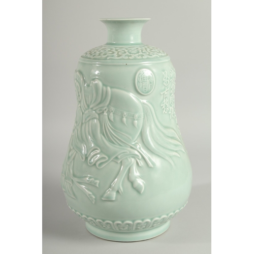 106 - A CHINESE CELADON GLAZE PORCELAIN VASE, the body carved with figures and a horse, 33cm high.