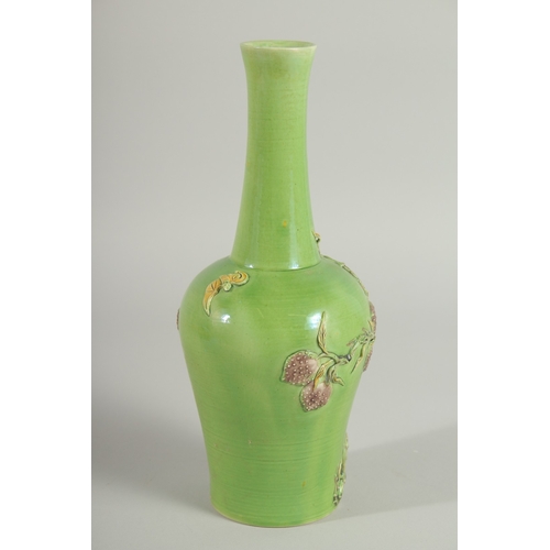 108 - A CHINESE GREEN GROUND CARVED PEACH VASE, with fine moulded and carved relief decoration around the ... 