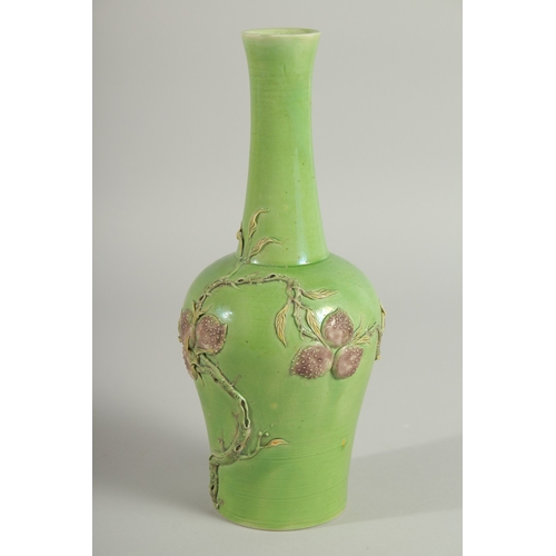 108 - A CHINESE GREEN GROUND CARVED PEACH VASE, with fine moulded and carved relief decoration around the ... 