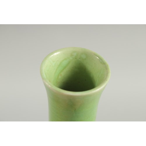 108 - A CHINESE GREEN GROUND CARVED PEACH VASE, with fine moulded and carved relief decoration around the ... 