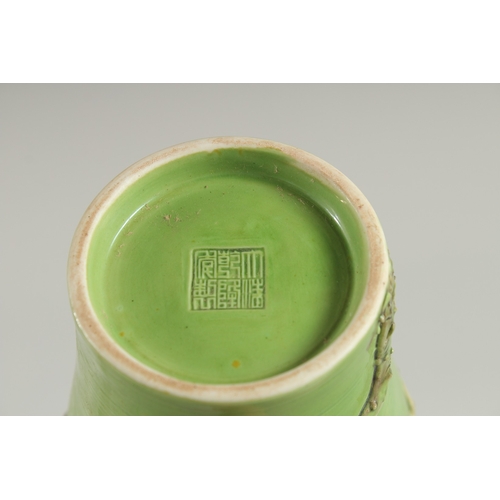 108 - A CHINESE GREEN GROUND CARVED PEACH VASE, with fine moulded and carved relief decoration around the ... 