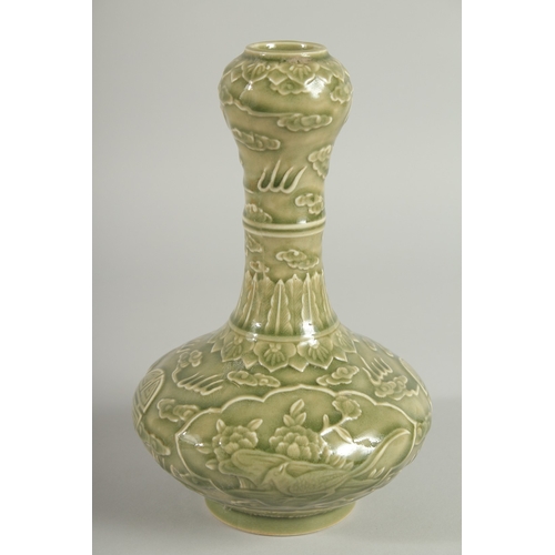 113 - A CHINESE OLIVE GREEN GLAZE CARVED GARLIC-HEAD VASE, with panels of birds and flora, 22.5cm high.