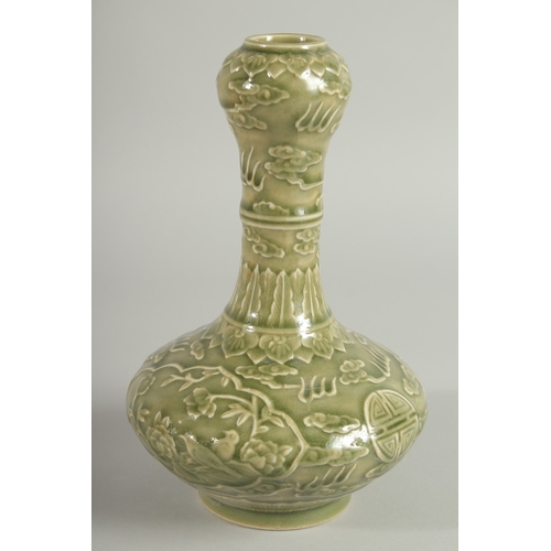 113 - A CHINESE OLIVE GREEN GLAZE CARVED GARLIC-HEAD VASE, with panels of birds and flora, 22.5cm high.