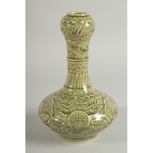 113 - A CHINESE OLIVE GREEN GLAZE CARVED GARLIC-HEAD VASE, with panels of birds and flora, 22.5cm high.