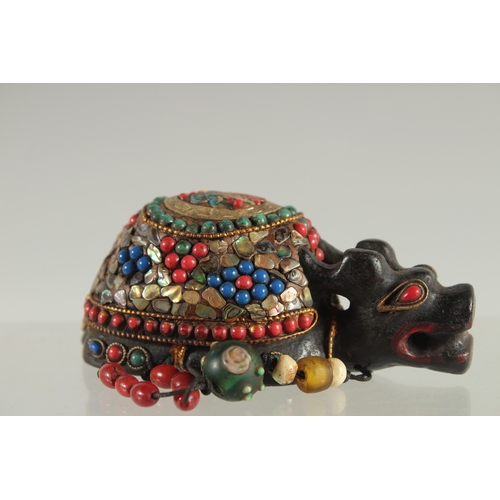 119 - A TIBETAN ABALONE INLAID FIGURE OF A TORTOISE, inset with various other beads, 9cm long.