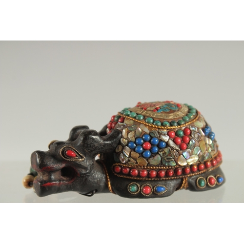 119 - A TIBETAN ABALONE INLAID FIGURE OF A TORTOISE, inset with various other beads, 9cm long.