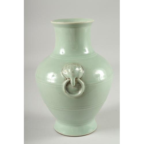 124 - A CHINESE CELADON GLAZED VASE, with moulded drop ring handles, the base with character mark, 25.5cm ... 