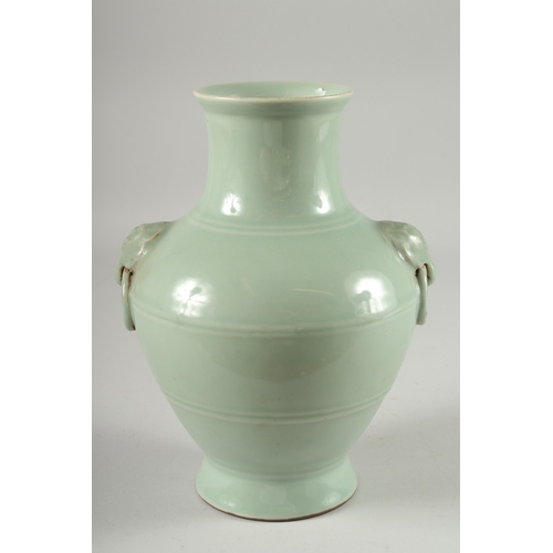 124 - A CHINESE CELADON GLAZED VASE, with moulded drop ring handles, the base with character mark, 25.5cm ... 