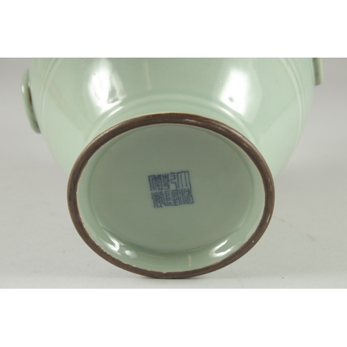 124 - A CHINESE CELADON GLAZED VASE, with moulded drop ring handles, the base with character mark, 25.5cm ... 