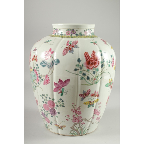 125 - A LARGE CHINESE FAMILLE ROSE PORCELAIN VASE, painted with flora and butterflies, 34cm high.