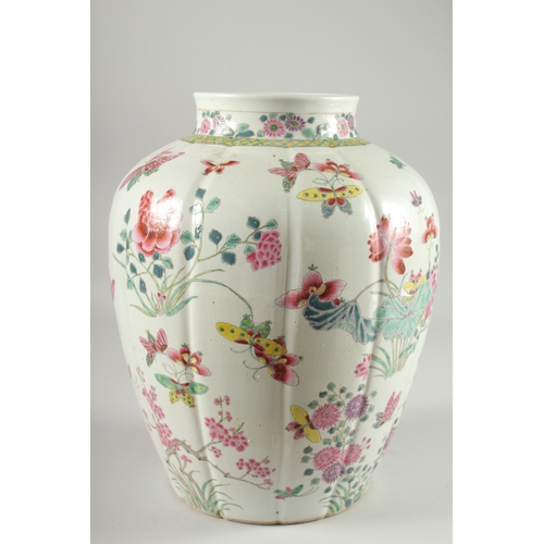 125 - A LARGE CHINESE FAMILLE ROSE PORCELAIN VASE, painted with flora and butterflies, 34cm high.