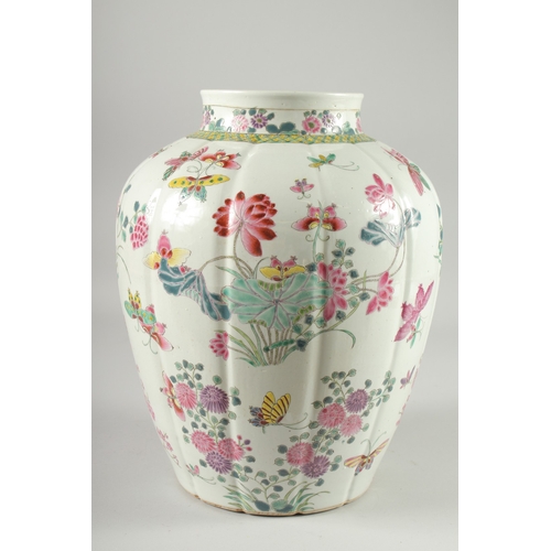 125 - A LARGE CHINESE FAMILLE ROSE PORCELAIN VASE, painted with flora and butterflies, 34cm high.