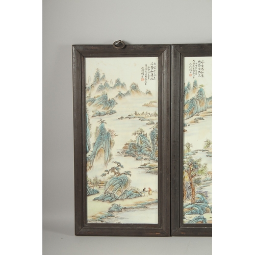 130 - FOUR CHINESE FAMILLE VERTE PORCELAIN PANELS, inset within wooden frames, each depicting mountainous ... 