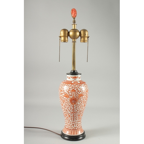 131 - A CHINESE COPPER RED AND WHITE PORCELAIN VASE LAMP, painted with floral motif decoration, the lamp w... 