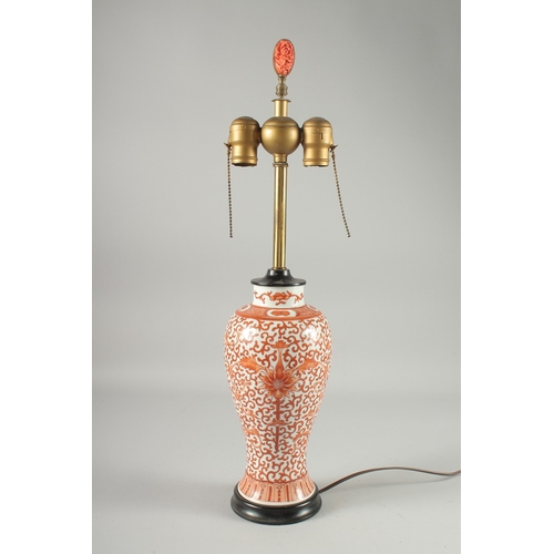 131 - A CHINESE COPPER RED AND WHITE PORCELAIN VASE LAMP, painted with floral motif decoration, the lamp w... 