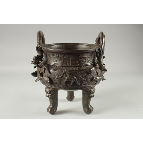 146 - A LARGE CHINESE BRONZE TWIN HANDLE TRIPOD CENSER, with relief horses and sea creatures, the handles ... 