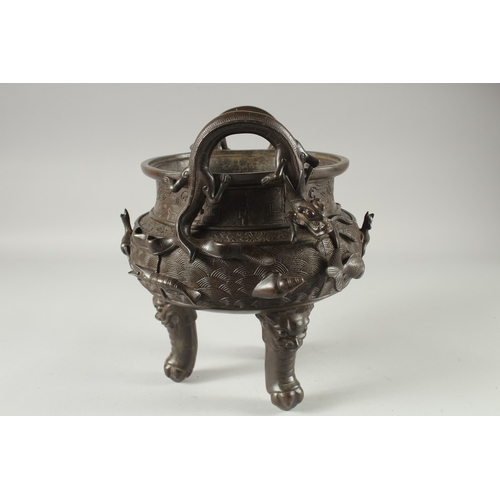 146 - A LARGE CHINESE BRONZE TWIN HANDLE TRIPOD CENSER, with relief horses and sea creatures, the handles ... 