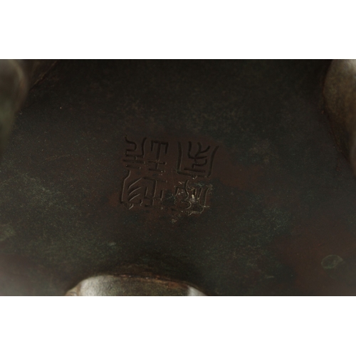 146 - A LARGE CHINESE BRONZE TWIN HANDLE TRIPOD CENSER, with relief horses and sea creatures, the handles ... 