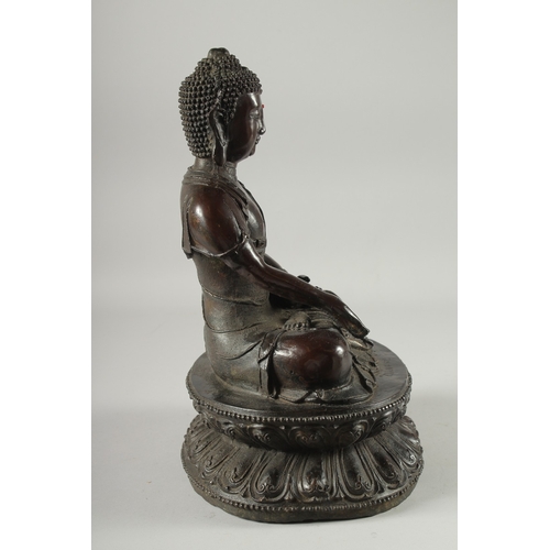 147 - A FINE LARGE BRONZE SEATED BUDDHA, the figure seated upon a double lotus base with character inscrip... 