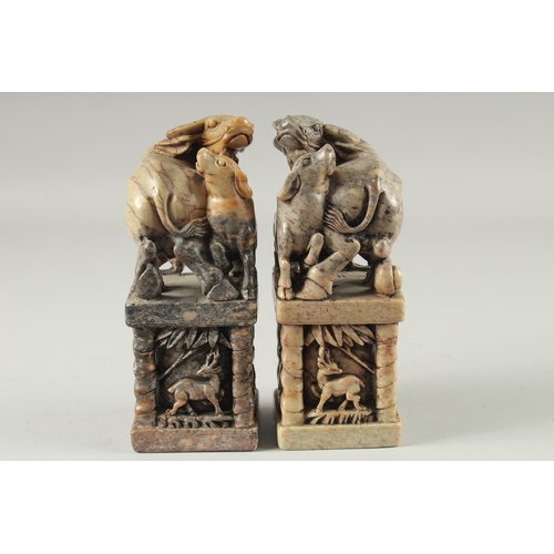 155 - A LARGE PAIR OF CHINESE CARVED BUFFALO SOAPSTONE SEALS, 20cm high.