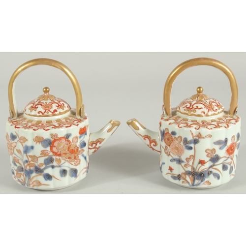 169 - A FINE PAIR OF CHINESE IMARI PORCELAIN TEAPOTS, painted in the typical Imari palette with blue, red ... 