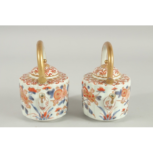 169 - A FINE PAIR OF CHINESE IMARI PORCELAIN TEAPOTS, painted in the typical Imari palette with blue, red ... 