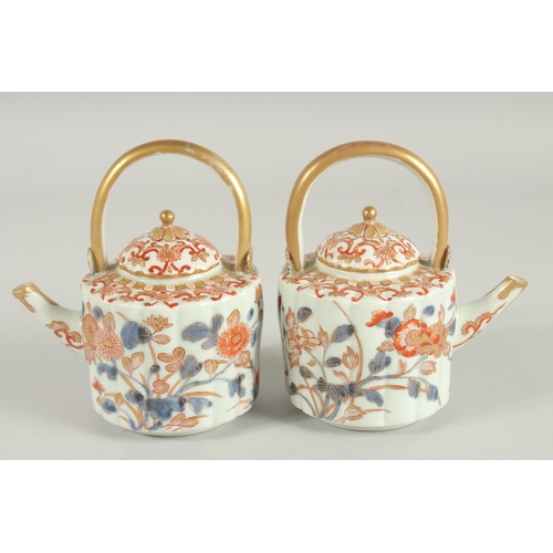 169 - A FINE PAIR OF CHINESE IMARI PORCELAIN TEAPOTS, painted in the typical Imari palette with blue, red ... 