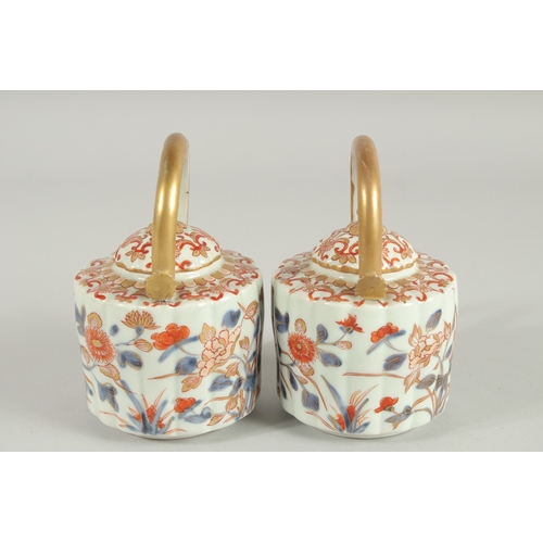 169 - A FINE PAIR OF CHINESE IMARI PORCELAIN TEAPOTS, painted in the typical Imari palette with blue, red ... 