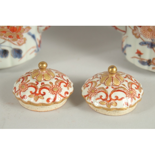 169 - A FINE PAIR OF CHINESE IMARI PORCELAIN TEAPOTS, painted in the typical Imari palette with blue, red ... 