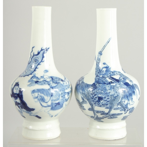 174 - A FINE PAIR OF CHINESE BLUE AND WHITE PORCELAIN BOTTLE VASES, one painted with a warrior riding a be... 