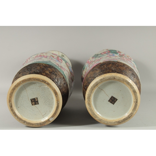 183 - A LARGE PAIR OF CHINESE FAMILLE ROSE PORCELAIN VASES, with moulded twin handles, each painted with a... 