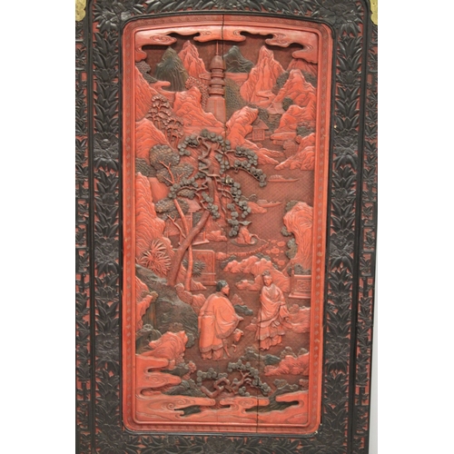 185 - A LARGE 19TH CENTURY CHINESE CARVED BLACK AND RED CINNABAR LACQUER PANEL, depicting two male figures... 