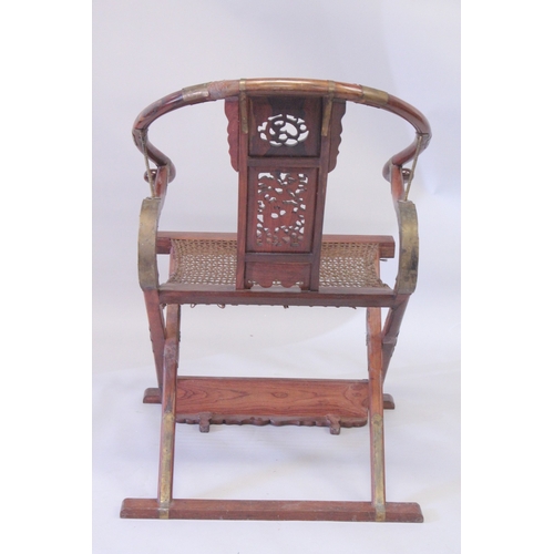 187 - A CHINESE HARDWOOD HORSESHOE-BACK FOLDING CHAIR, with carved and pierced kylin panel and netted seat... 